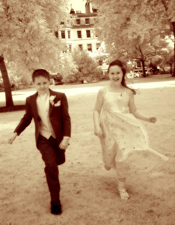 Photojournalism kids in formal attire running in London England park