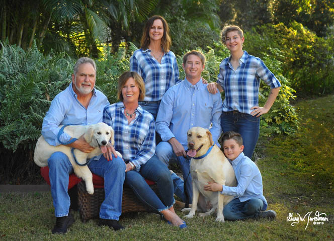 Family portrait at home outside with dogs plaid shirts