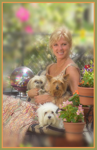 woman with Yorkies in garden setting